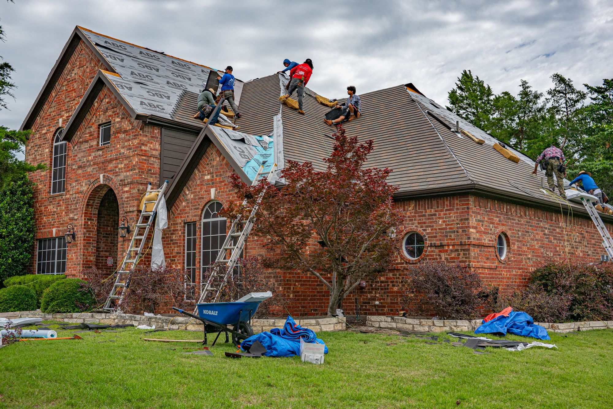 American roofing crew working on a shingle roof